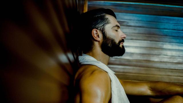 man relaxing in steam room