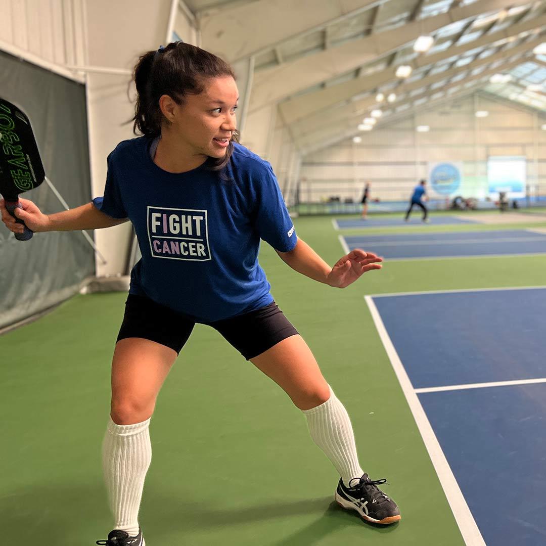 woman playing pickleball indoors